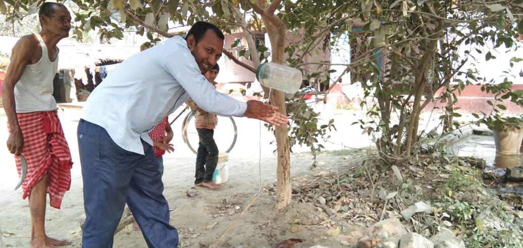 Ashok Paswah, while washing hands using the tippy tap (Image Source: Sehgal Foundation)