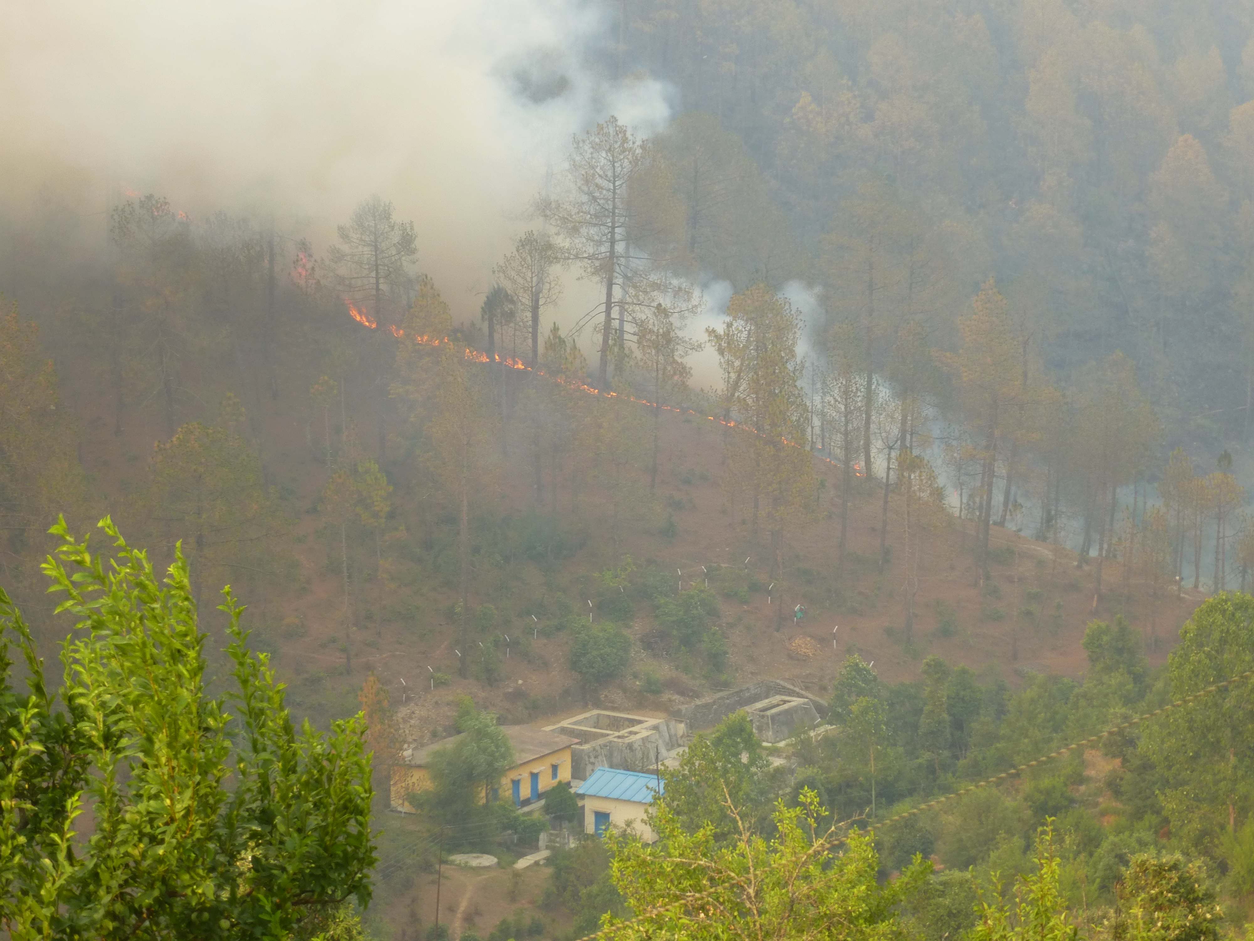 The fire approaches the pump house at the bottom of the valley