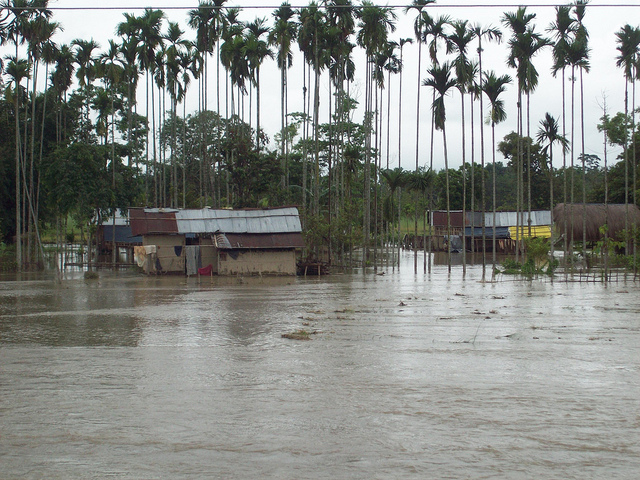 How can a 'recipient' basin receive water from a 'surplus' basin when both flood at the same time?