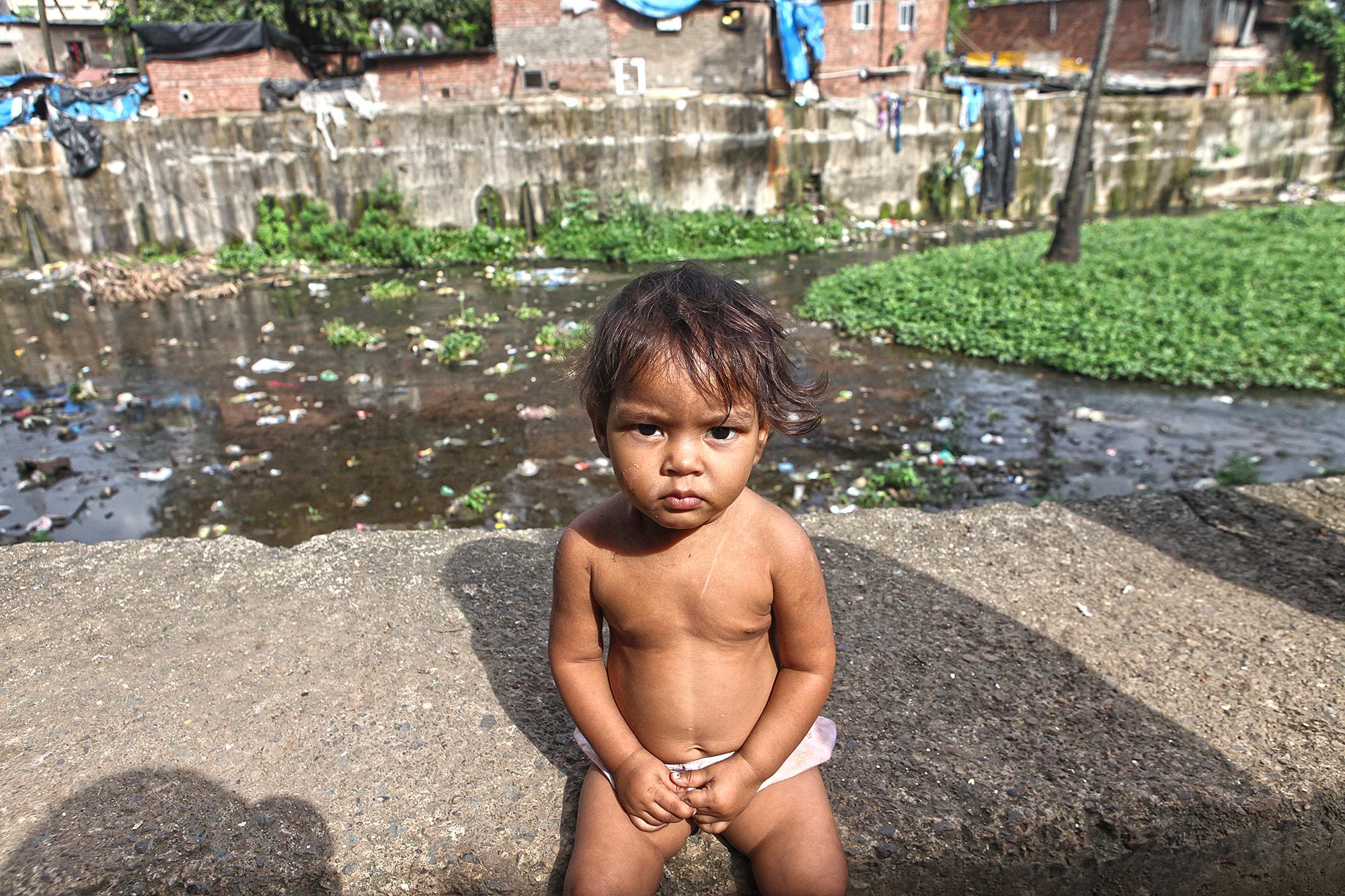 A little girl sitting on one of the retaining walls