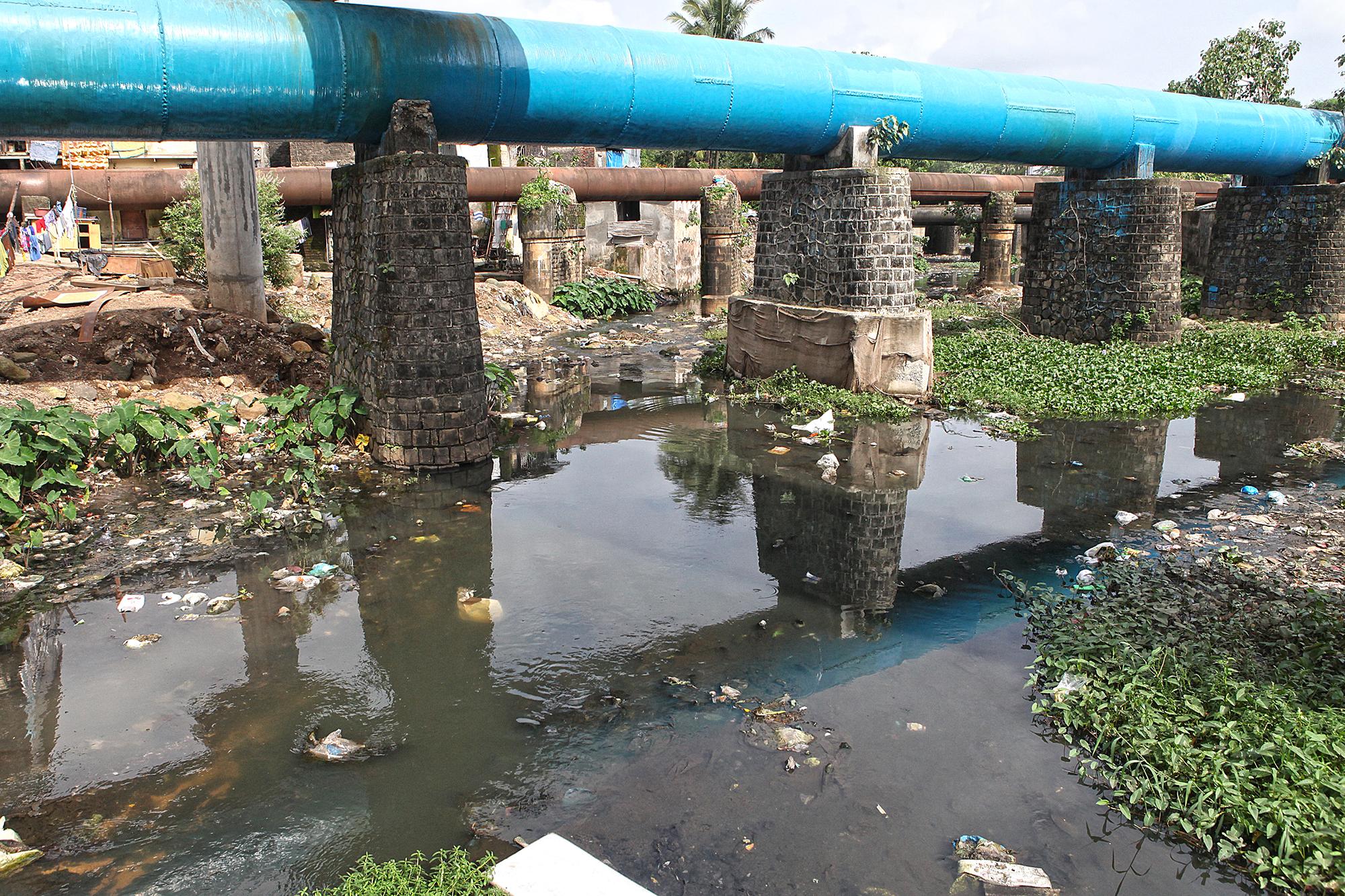 Freshwater pipeline passing above the Mithi river at Bhim Nagar