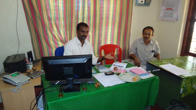 photo of two men sitting at a desk