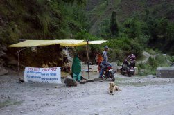 Protesters take turns sitting at road to block dam construction