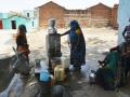 Women filling water from a tap (Source: IWP Flickr photos)