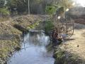 A villager washes utensils in the black water coming out of the coal mines at Kodkel in Raigarh district, Chattisgarh.