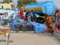 Residents of Kusumpur Pahari, a slum in south New Delhi, fill containers with water from a DJB tanker Source: Columbia Water Center/flickr