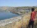 A villager looks at the changing landscape due to coal mines at Kosampalli village in Raigarh.