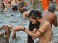 A priest offers water to the sun at Ramghat on the Kshipra river at Simhastha (Image Source: Makarand Purohit)