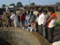 Manyali residents testing water from their well