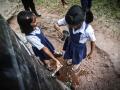 Children drinking rainwater collected in tanks at Melamati Government Junior Basic School, Jorhat (Assam).