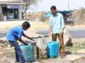 People take water from a common water point. (Source: SaciWATERs)