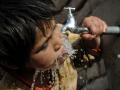 Child drinks water from a tap (Image: Imal Hashemi/Taimani Films/World Bank, Flickr Commons, CC BY-NC-ND 2.0)