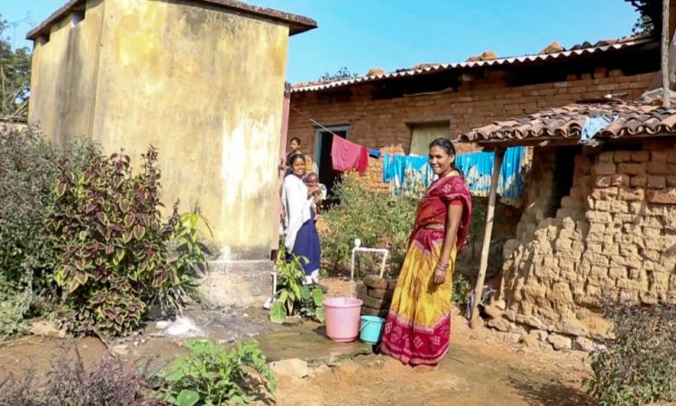 A woman fetching water from the third tap in the house premises. (Image: Ajaya Kumar Behera)