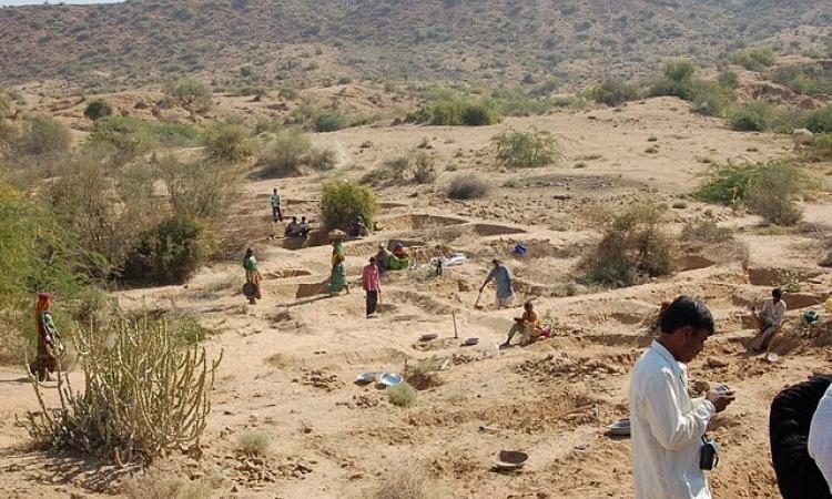 Labourers building check dams under MGNREGS (Source: IWP Flickr Photos)