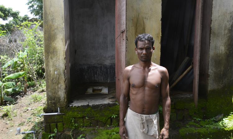 Anup Munda showing his functional toilet at Bandha Bhuin