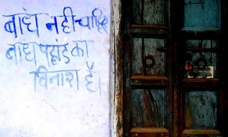 We don't want dams, dams destroy mountains' reads a slogan painted on a wall in Uttarakhand (Image Source: GJ Lingaraj)