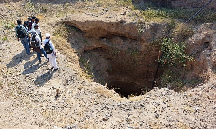 A study group observing groundwater in a well