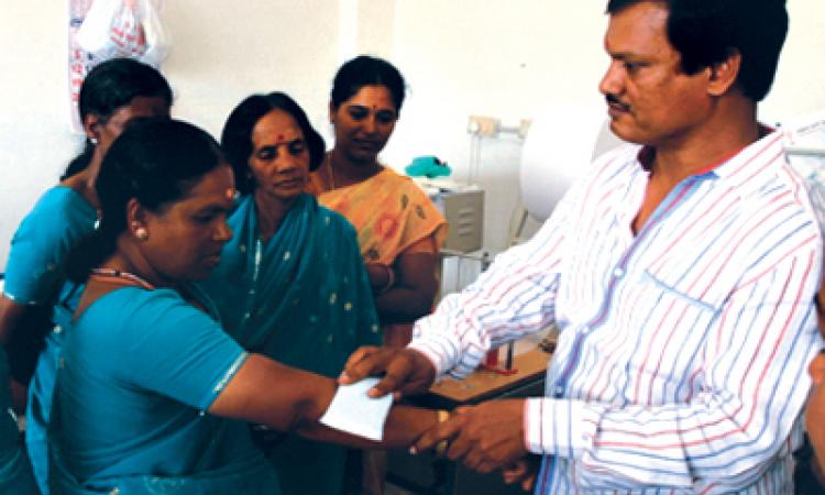 A Muruganantham shows the working of a sanitary pad to women. (Source: The Pad Piper)