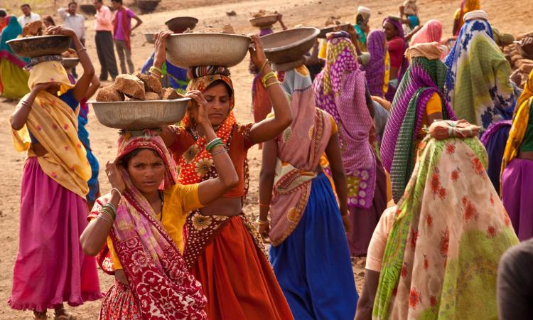 Women working on an NREGA site building a pond to assist in farming and water storage. Gopalpura, Jhabua, Madhya Pradesh (Image: UN Women/Gaganjit Singh, Flickr Commons)