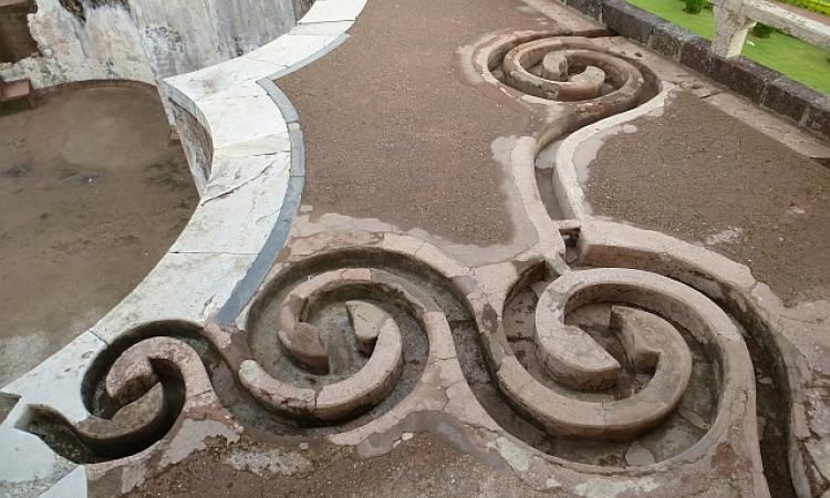 An intricate set of curlicues set in the floor leads rainwater from the roofs to a tank in Jahaz Mahal, Mandu