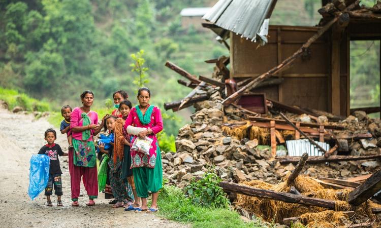 A family beside a damaged house near Naglebhare, Nepal (Source :Asian Development Bank)